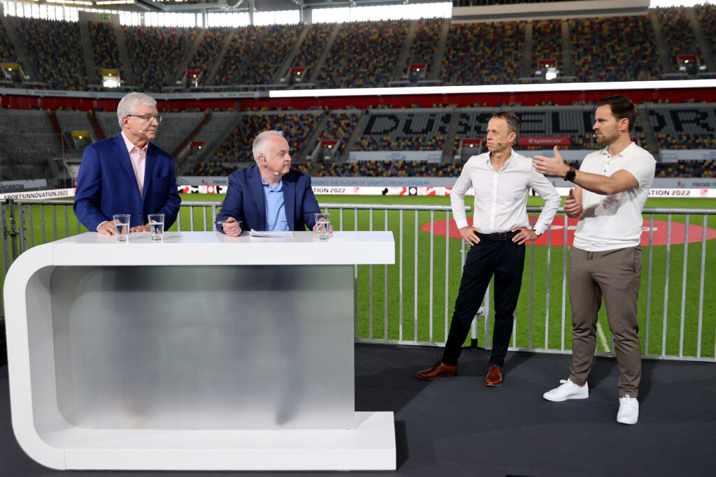 DUESSELDORF, GERMANY - MAY 12: Maximilian Schmidt of Kinexon, Frank Bohmann of LIQUI MOLY HBL, Steve Hellmuth of NBA and Derek Rae chat during Day 2 of the Sportsinnovation 2022 at Merkur Spiel-Arena on May 12, 2022 in Duesseldorf, Germany. (Photo by Boris Streubel/Bundesliga/Bundesliga Collection via Getty Images)